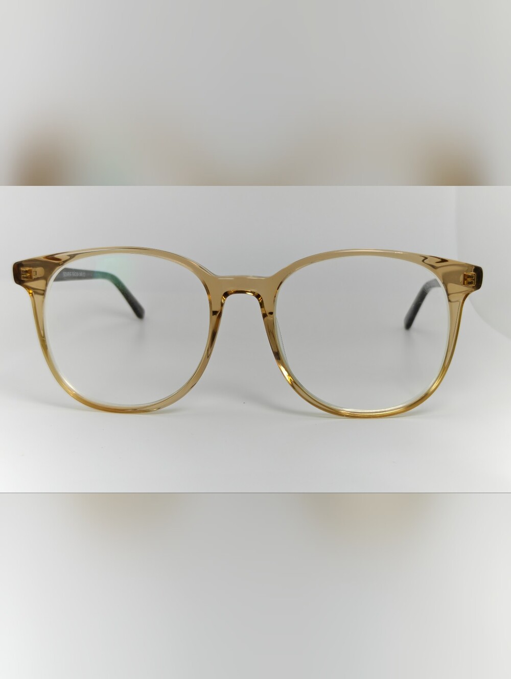 Solveig. Transparent Amber Round Eyeglasses. Animal Print temples.